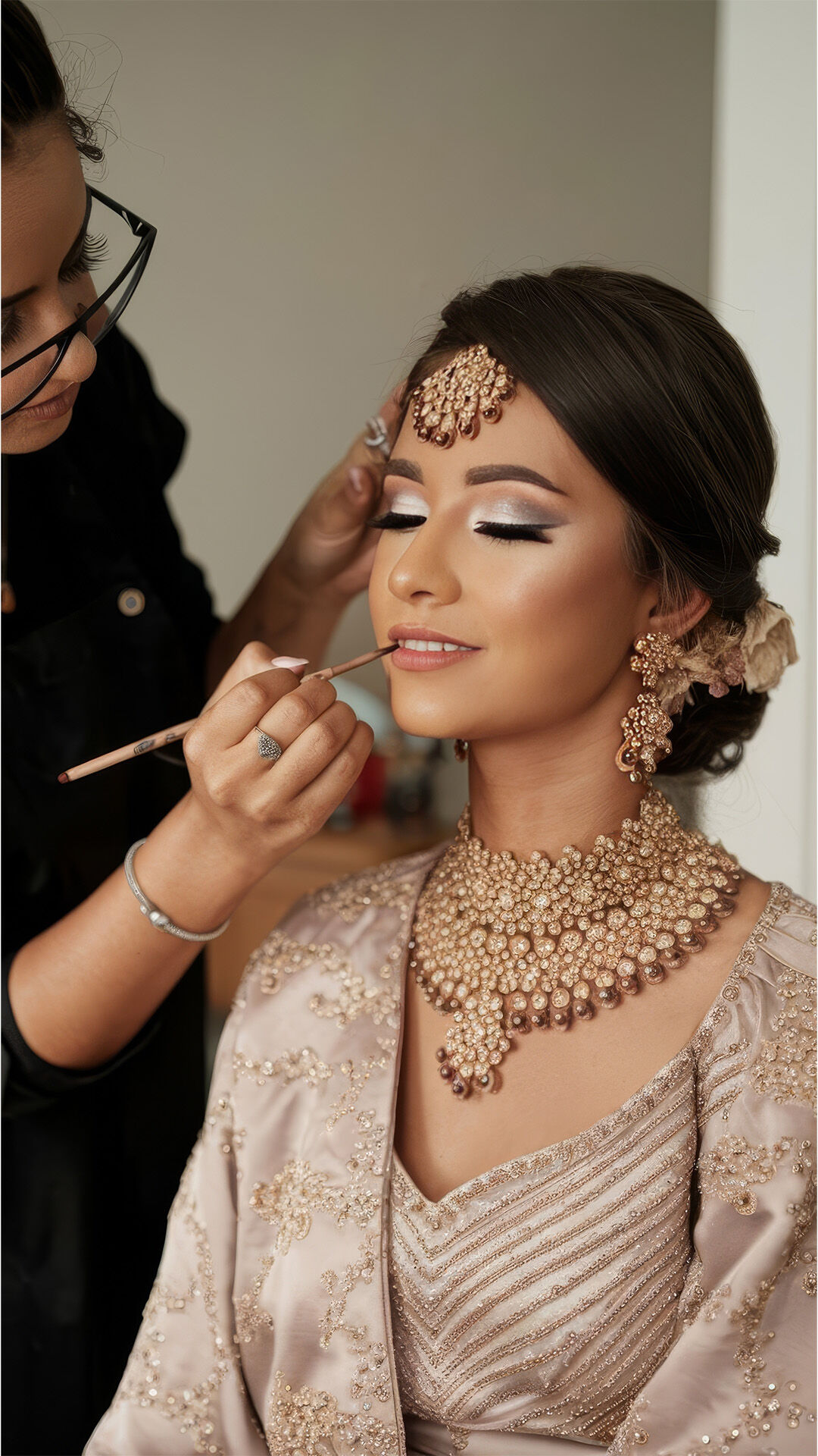 A bride getting makeup done by proffesional makeup artist